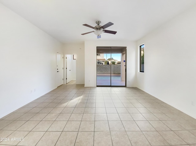 empty room featuring ceiling fan and light tile patterned flooring