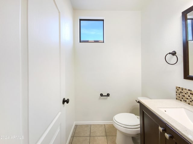 bathroom with tile patterned flooring, vanity, and toilet