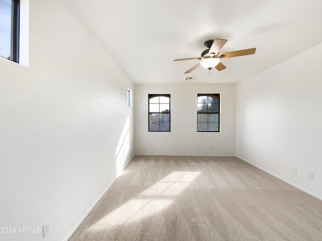 spare room with light colored carpet and ceiling fan