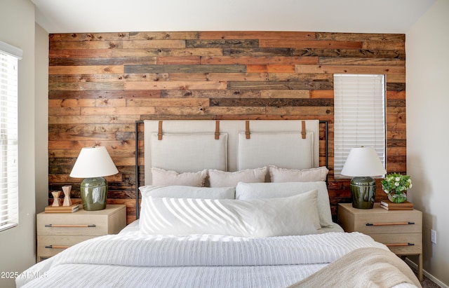 bedroom featuring wooden walls