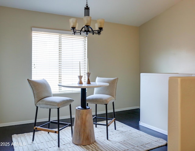 dining area featuring plenty of natural light and a notable chandelier