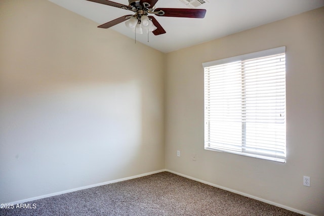 spare room featuring ceiling fan, carpet flooring, and a healthy amount of sunlight