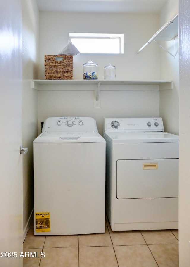 laundry area with washing machine and dryer and light tile patterned flooring