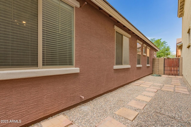 3756 E Kerry Ln, Phoenix, AZ 85050 - view of property exterior featuring a gate and stucco siding