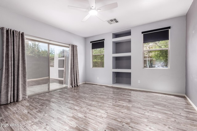 3756 E Kerry Ln, Phoenix, AZ 85050 - spare room featuring built in features, plenty of natural light, wood finished floors, and baseboards