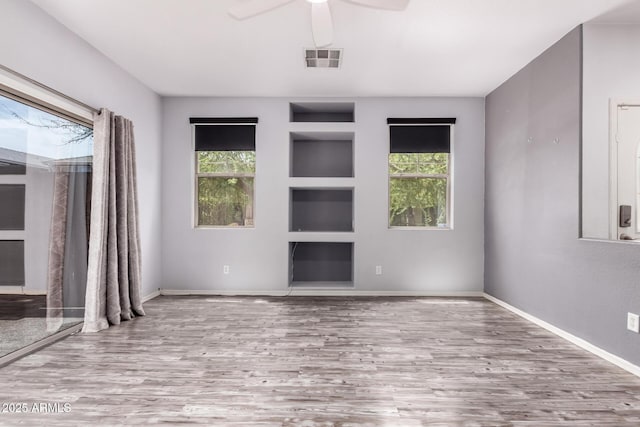 3756 E Kerry Ln, Phoenix, AZ 85050 - unfurnished room featuring built in shelves, wood finished floors, ceiling fan, and baseboards