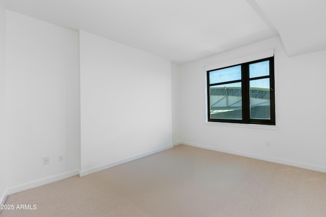 empty room with carpet and baseboards