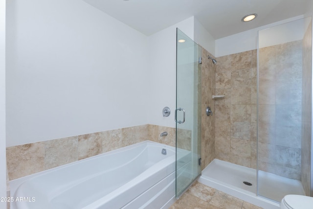 bathroom featuring a shower stall, recessed lighting, and a bath