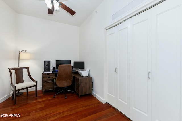 office space with baseboards, a ceiling fan, vaulted ceiling, and dark wood-style floors