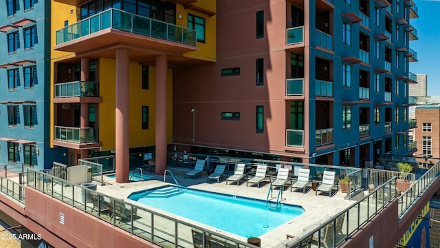 view of pool featuring fence and a patio