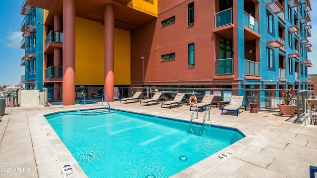 pool featuring a patio and fence