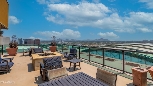 balcony featuring a fire pit and a mountain view