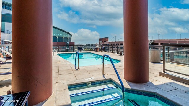 pool featuring a patio area and a hot tub