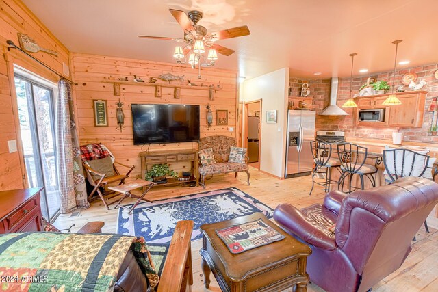 2353 Florian Meadow Trl, Overgaard, AZ 85933 - living area with wooden walls, light wood-style floors, and ceiling fan