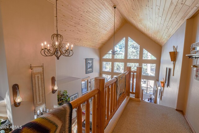 2353 Florian Meadow Trl, Overgaard, AZ 85933 - hallway with high vaulted ceiling, an upstairs landing, wood ceiling, carpet, and an inviting chandelier