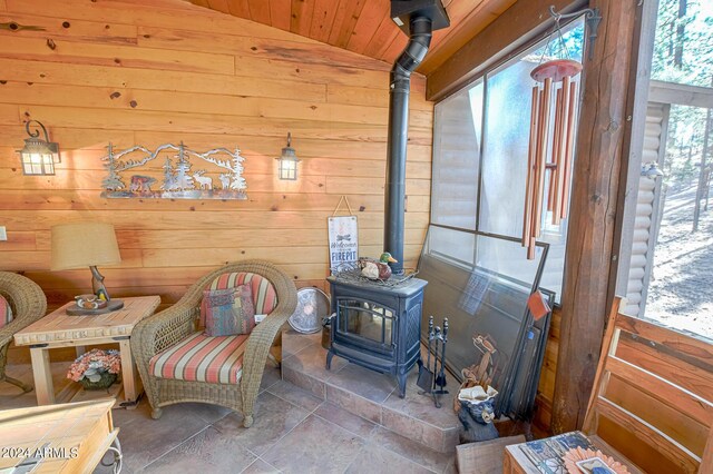 2353 Florian Meadow Trl, Overgaard, AZ 85933 - sitting room with wood ceiling, wooden walls, vaulted ceiling, and a wood stove