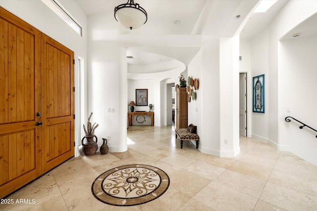 15816 E Eagle Crest Rd, Fountain Hills, AZ 85268 - foyer with arched walkways, baseboards, light tile patterned floors, and a high ceiling