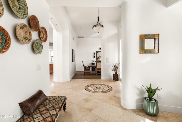 15816 E Eagle Crest Rd, Fountain Hills, AZ 85268 - hallway with baseboards, light tile patterned floors, and arched walkways