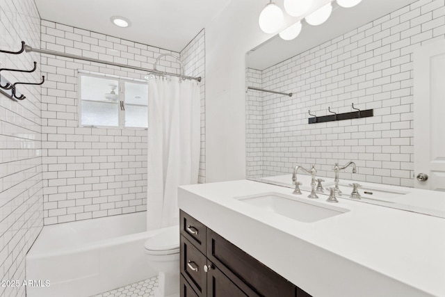 full bath with toilet, shower / tub combo, tile walls, and vanity