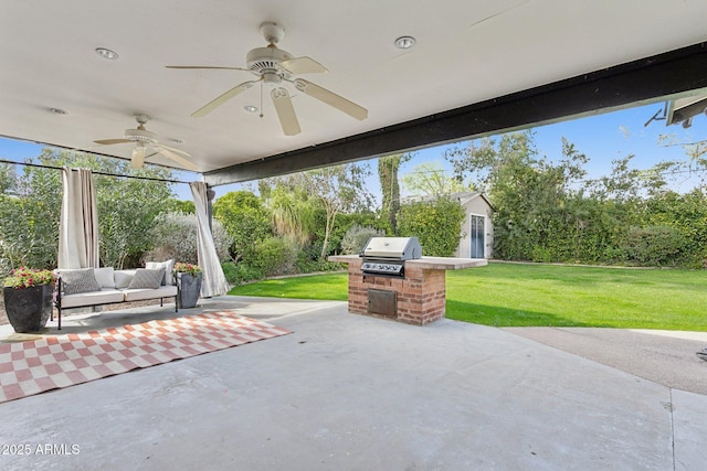 view of patio / terrace featuring an outdoor kitchen, an outdoor structure, an outdoor living space, a ceiling fan, and grilling area