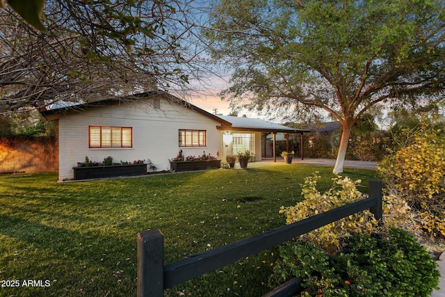 exterior space with a patio area, fence, and a lawn