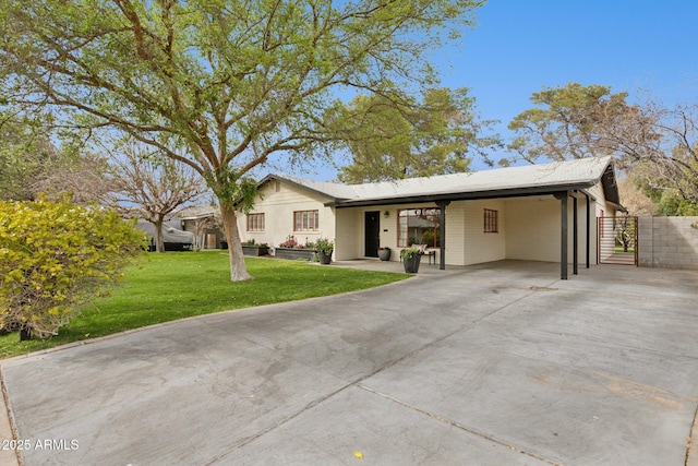single story home featuring fence, driveway, a gate, a carport, and a front yard