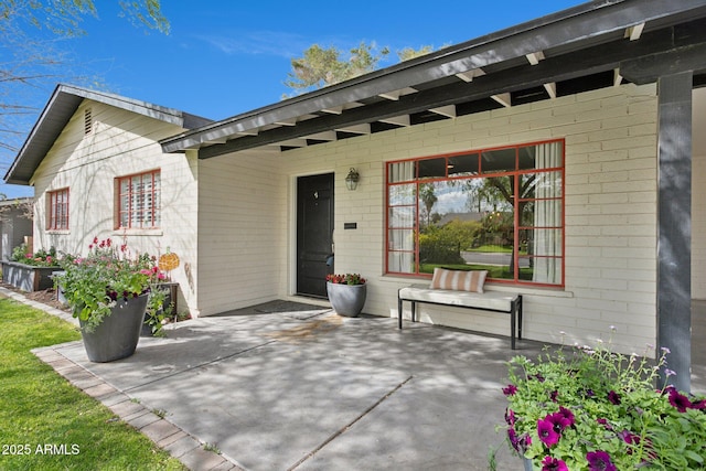 doorway to property with brick siding