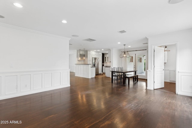 unfurnished dining area featuring visible vents, ornamental molding, dark wood-style flooring, and recessed lighting
