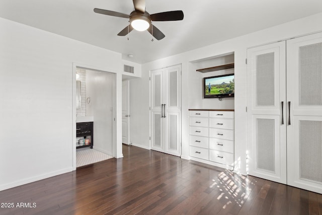 unfurnished bedroom with a ceiling fan, visible vents, baseboards, wood-type flooring, and two closets