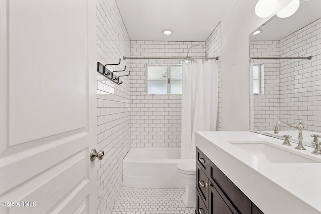 bathroom featuring toilet, shower / bathtub combination with curtain, tile patterned flooring, and vanity