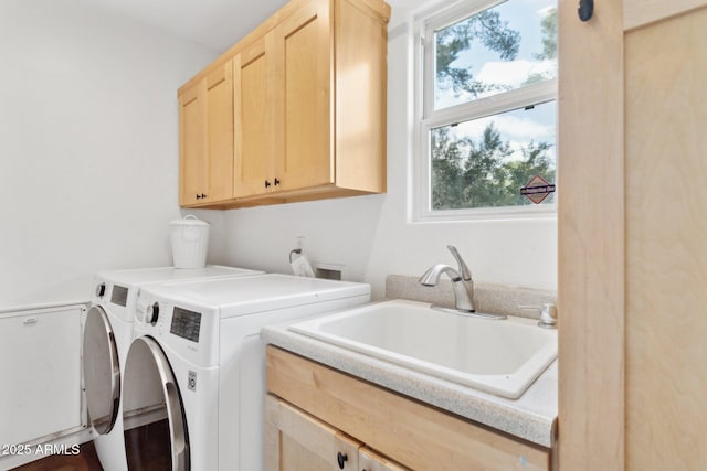 laundry room featuring cabinet space, a sink, and independent washer and dryer