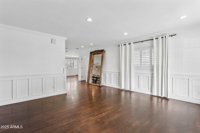 unfurnished room featuring plenty of natural light, ornamental molding, wood finished floors, and recessed lighting