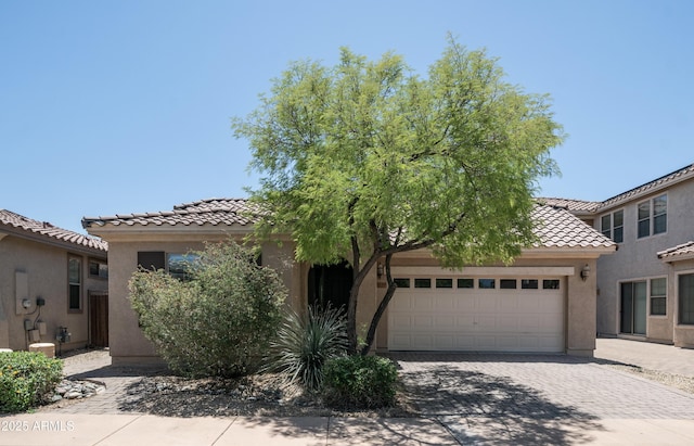3439 W Darien Way, Phoenix, AZ 85086 - view of front of home featuring a tiled roof, an attached garage, stucco siding, and decorative driveway