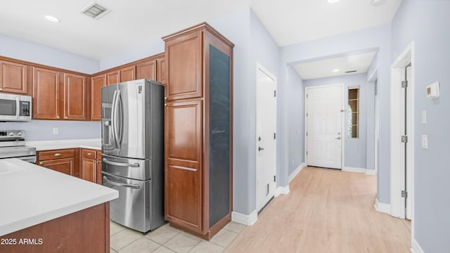 3439 W Darien Way, Phoenix, AZ 85086 - kitchen featuring appliances with stainless steel finishes, light countertops, brown cabinetry, baseboards, and recessed lighting