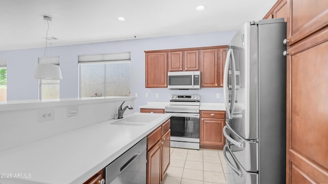 3439 W Darien Way, Phoenix, AZ 85086 - kitchen featuring appliances with stainless steel finishes, a sink, light countertops, light tile patterned flooring, and hanging light fixtures