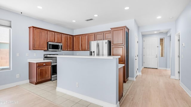 3439 W Darien Way, Phoenix, AZ 85086 - kitchen with stainless steel appliances, light wood finished floors, light countertops, brown cabinetry, and recessed lighting