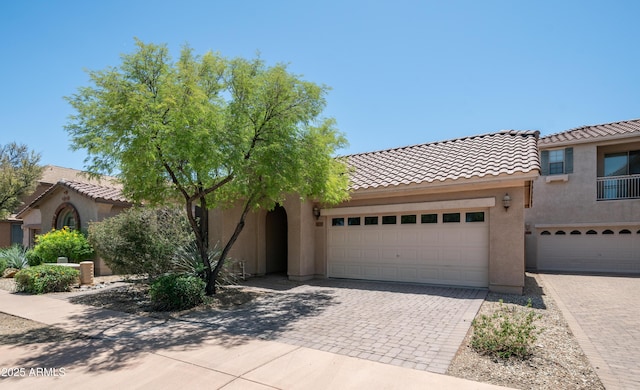 3439 W Darien Way, Phoenix, AZ 85086 - mediterranean / spanish-style house with decorative driveway, stucco siding, a tiled roof, and an attached garage