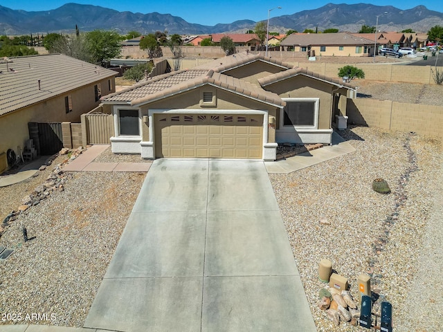 2386 Skyview Dr, Sierra Vista, AZ 85635 - view of front of property featuring a mountain view, stucco siding, a garage, and concrete driveway