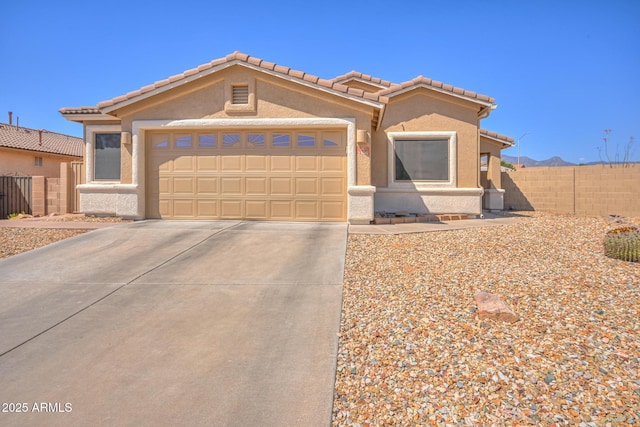 2386 Skyview Dr, Sierra Vista, AZ 85635 - view of front facade with stucco siding, concrete driveway, an attached garage, and a tiled roof