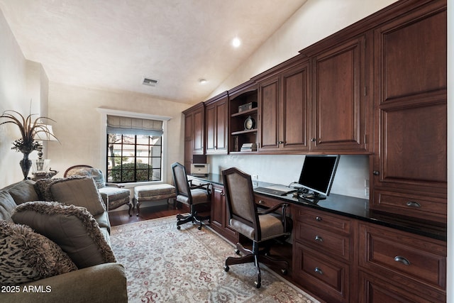 office space featuring built in desk, light hardwood / wood-style floors, and vaulted ceiling