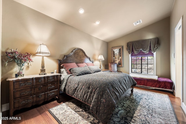 bedroom with lofted ceiling and dark wood-type flooring