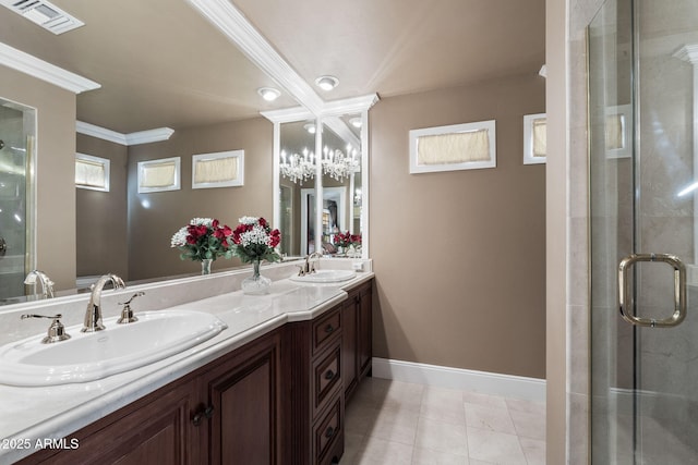 bathroom with a shower with door, vanity, tile patterned floors, and crown molding