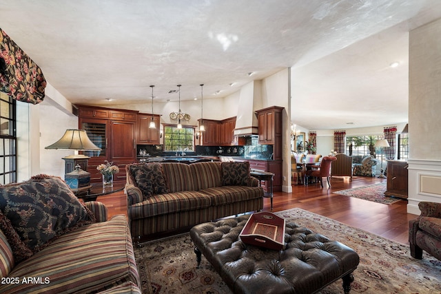 living room with dark wood-type flooring and lofted ceiling