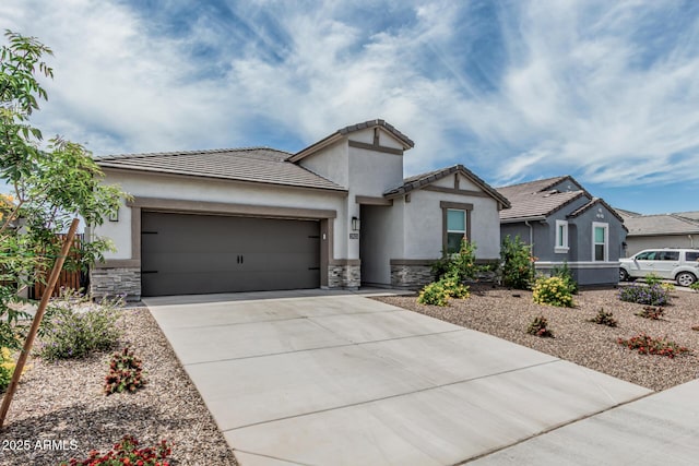 2923 W Shanley Ave, Apache Junction, AZ 85120 - view of front facade with a garage, driveway, stone siding, and stucco siding