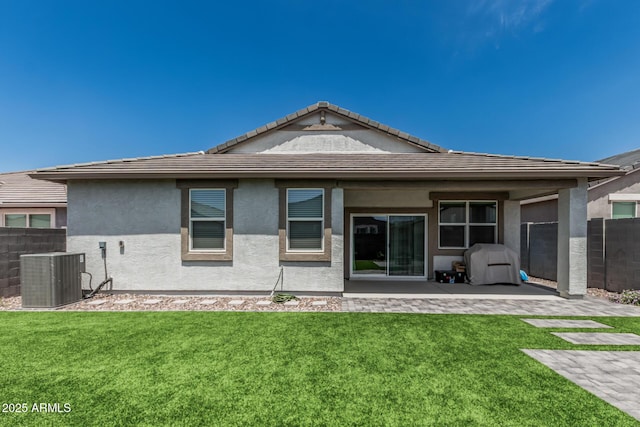 2923 W Shanley Ave, Apache Junction, AZ 85120 - back of house featuring central air condition unit, fence, a yard, and a patio area