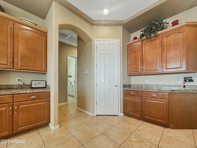 kitchen featuring light tile patterned floors and crown molding