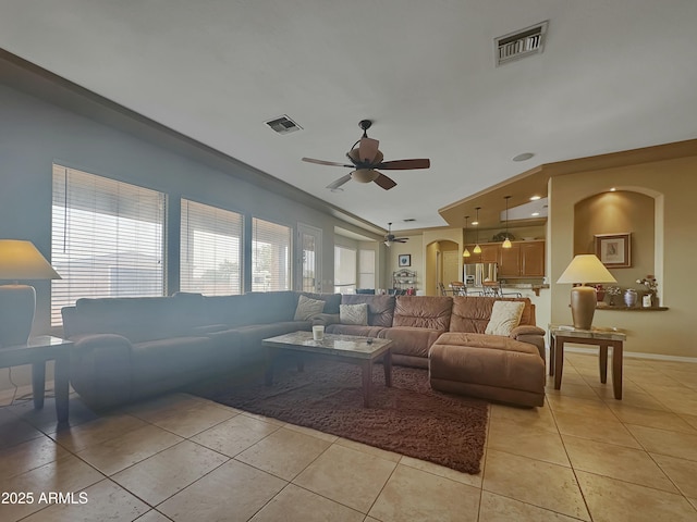 tiled living room with ceiling fan