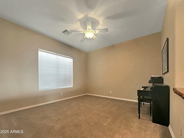 carpeted spare room featuring ceiling fan