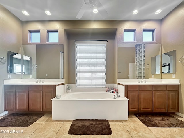 bathroom featuring tile patterned floors, a bathtub, and vanity