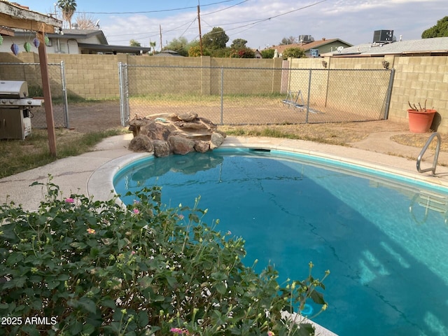 view of swimming pool with grilling area